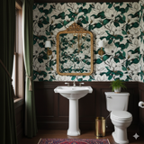 Magnolia-patterned Savannah Row Wallpaper with green leaves on an off-white background, above dark-stained wainscoting.