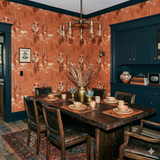 Ember Frontier Tableau Wallpaper with a Southwestern motif and a repeating pattern of skeletons and cacti.