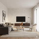 Ink scatter wallpaper featuring a black and white pattern on a textured wall in a living room setting.