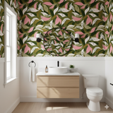 Green and pink floral patterned wallpaper with leaves and petals, complementing a modern bathroom design.
