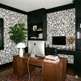 Black and white Inkline Carousel Wallpaper with an abstract swirling pattern, covering the walls in an office setting.