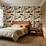 Abstract patterned wallpaper with shapes by Gust Drift, on a bedroom wall.