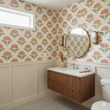 Kaveri Lotus Wallpaper with floral pattern, in a bathroom setting with wainscoting and a floating vanity.
