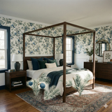 Juniper wallpaper with blue berries by Bluewake featuring a botanical pattern in a bedroom setting.