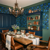 Blue floral curtain wallpaper with bluebell pattern, covering walls with green painted trim.