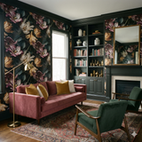 Floral wallpaper with dark backdrop and tulip pattern, covering the walls of a dark and elegant living room.

