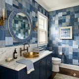 Blue patchwork atelier wallpaper with indigo tones, from a vendor, featuring a geometric pattern in a styled bathroom setting.
