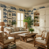 St. Johns River Ledger Wallpaper with a blue tropical print, covering the walls of a living room setting.
