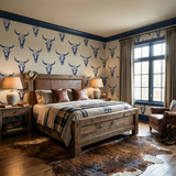 Relic wallpaper with a steer skull pattern, by Lone Mesa, in a bedroom with western decor.
