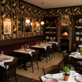 Vintner’s Study Wallpaper with wine bottle pattern, decorating a restaurant interior.