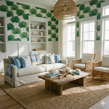 Cape Verde Fanleaf wallpaper with a green botanical pattern, styled in a coastal living room.
