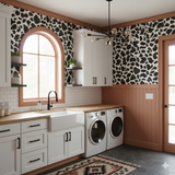 Freemont Hide Wallpaper with black and white animal print pattern, covering the walls in a laundry room.
