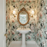 Patterned wallpaper by Ashford House featuring magnolia flowers and dalmatian dog designs in a stylish bathroom.