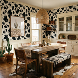 Black and white Oxenveil Wallpaper with a cowhide-inspired pattern on the wall.