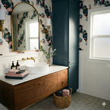 Patterned wallpaper with circular geometric shapes, featuring pink, teal, and green hues on an off-white background.