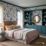 Floral Lavender Wick Wallpaper with purple flowers and green leaves, filling a bedroom wall.
