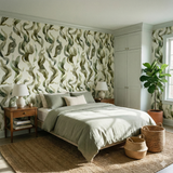 Green Lyria Tidescape Wallpaper with foliage pattern, styled in a bedroom, covering the walls behind a bed.
