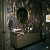Gilded Thicket Noire wallpaper with a fern and leaf pattern, decorating a modern bathroom.
