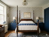 Nocturne Compass Wallpaper with navy star pattern over tan background on the bedroom wall.