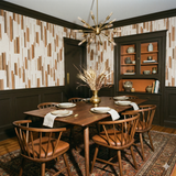 Patterned switchgrass fringe wallpaper with brown vertical stripes, for a dining room.
