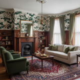 Savannah Row floral wallpaper featuring a white and green pattern, on the upper half of paneled walls in a vintage-styled room.