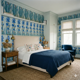 Floral iris promenade wallpaper with blue flowers and green stems, decorative molding and trim.