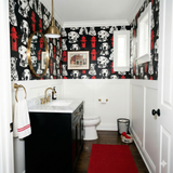 Metro Muse Wallpaper with dalmatian and fire hydrant pattern over black background, covering walls in bathroom setting.