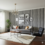 Striped wallpaper from York Wallcoverings, covering the wall in bold, textured black and white stripes.
