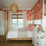 Coraline Shoals wallpaper in red and white featuring a coral pattern.

