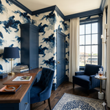 Indigo steeplechase wallpaper with horse and rider motif, covering the walls in an elegant room.