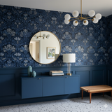 Indigo Regency wallpaper with a damask pattern covering the wall from baseboard to ceiling.