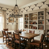 Patterned wallpaper with steer skulls from Redrock, covering the walls of a dining room.