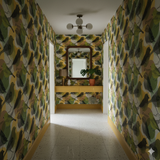 Patterned larkshade wallpaper featuring bird motifs, with yellow and green hues.
