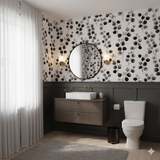 Black and white botanical wallpaper with leaves from Ashgrove, covering a bathroom wall.