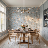 Floral wallpaper in pastel blue tones featuring climbing branches and light peach blossoms.
