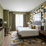 Patterned Amberline Wallpaper with a retro geometric design, featured on an accent wall in a modern bedroom.
