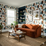 Patterned Midlake Shuffle Wallpaper with abstract shapes and color blocks, covering the wall.
