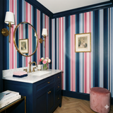 Striped wallpaper with pink and blue stripes, patterned bathroom background.