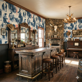 Cattleman’s Field Notes wallpaper featuring a western cowboy pattern, in a room with a saloon bar and stone fireplace.