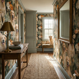 Floral golden retriever wallpaper with dog portraits, in a hallway featuring a mirror and table.