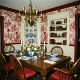Traditional patterned wallpaper with red toile design featuring dogs and country scenes.