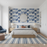 Indigo and white patterned wallpaper with geometric shapes by Brewster Home Fashions, adorning a bedroom wall.