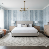 Blue and white Frosted Grove Wallpaper with a birch tree pattern on the bedroom wall.