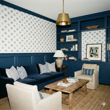 Fairway Index Wallpaper with blue dots by Schumacher, visible on the upper portion of the wall, above navy blue wainscoting.