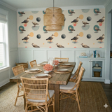 Tideline Orbit Wallpaper with beige background and bird and sphere pattern.