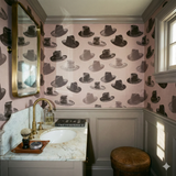 Milliner's Table Wallpaper with hat pattern on pink textured background.