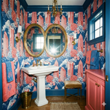 Patterned wallpaper by Schumacher featuring coral skyscrapers and floral toile accents.

