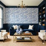 Botanical print wallpaper with blue leaf pattern on cream background.
