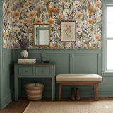 Floral wallpaper with deer accents, from Wildbloom Haven, covering the top half of an entryway with green wainscoting.