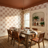Copper rosette field wallpaper with a floral tile pattern, decorative trim, and complementary ceiling color.